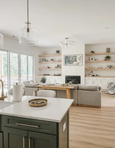 A kitchen with a large island and hardwood floors.